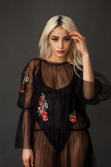 Beautiful blonde woman portrait wearing black tulle dress
