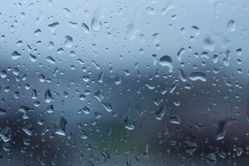 The texture of rain drops on the glass from the shower