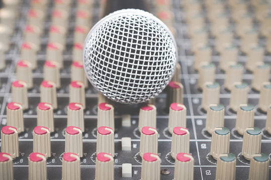 dynamic microphone on audio mixing board