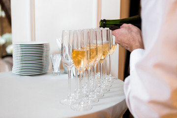 waiter pours champagne