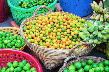 Basket of fresh tangerines in street market in Can Tho