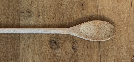Wooden spoon in kitchen on wooden background