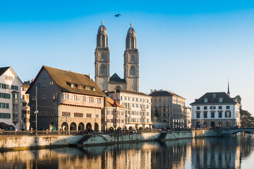 Fototapeta na wymiar Limmat River Quay and Grossmunster Church in Zurich, Switzerland.