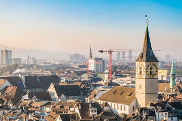 Downtown of Zurich city center and famous church clock tower on sunny day in winter season