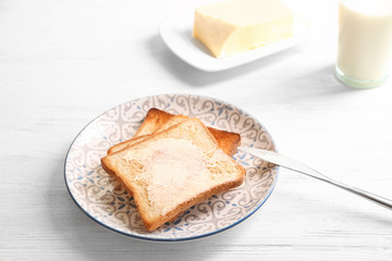 Tasty toasted bread with butter on plate