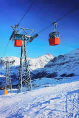 Fototapeta na wymiar Cable car cabins at winter sport resort Swiss Alps Mannlichen