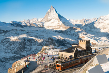 Skiers and snowboarder were preparing to ski at Gornergrat bahn train station with matterhorn peak view at the background of ski track..