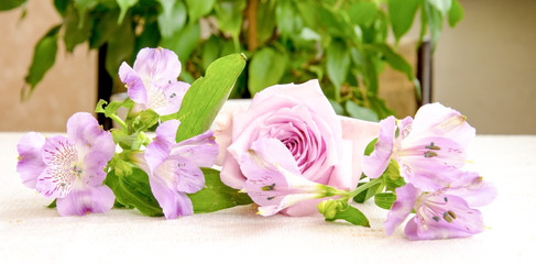 Beautiful bouquet of  pink alstroemeria and rose flower on linen cloth