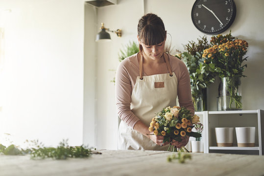 Young Florist Arranging A Mixed Flower Bouquet In Her Shop