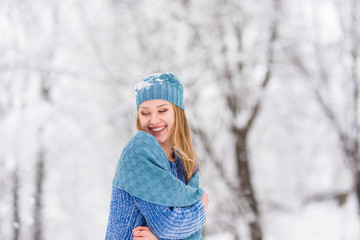 Winter girl blowing snow. Beauty Joyful Teenage Model Girl having fun in winter park.
