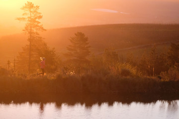 female trail runner in the mountains with beautiful light