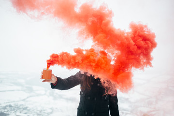 Hipster woman holding smoke bomb