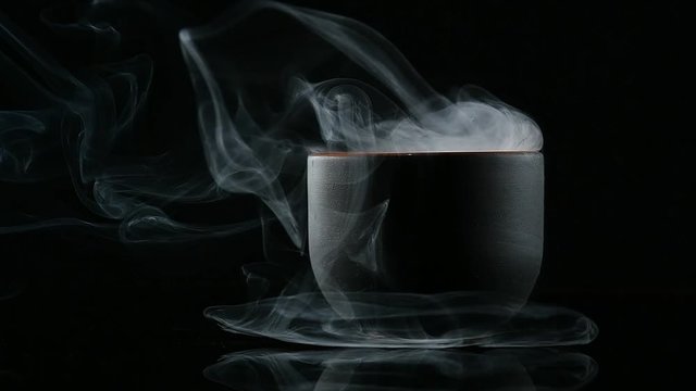 mystical smoke from cups on a black background
