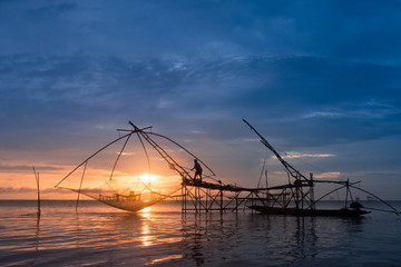 Obraz na płótnie Canvas Fisherman using huge fishing equipment called 'Yor' in Phatthalung, southern Thailand