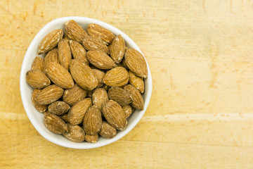 Almond seeds in a bowl. View from above.