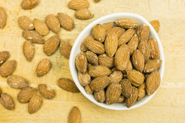 Shelled almond seeds in a bowl. View from above.