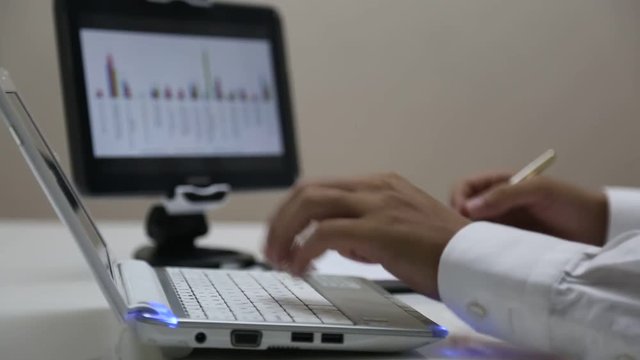 Businessman using laptop and tablet
