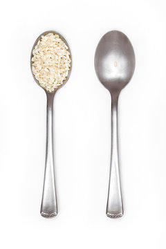 food inequality, two spoons: one full of rice and the other with just a grain