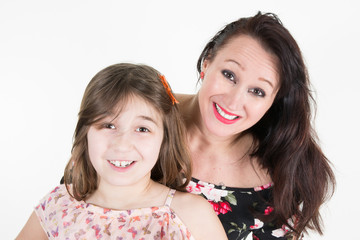 young mother with little cute daughter emotional posing on white