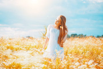 Beauty girl outdoors enjoying nature. Beautiful teenage model girl with healthy long hair in white...