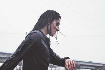 Woman doing sport in the open air, on rainy day