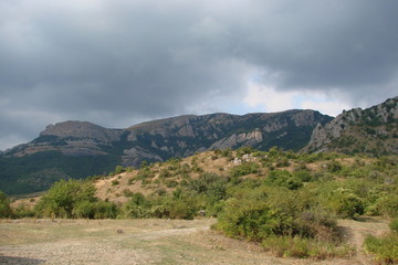 Fototapeta na wymiar Crimean rocks against the background of cloudy rainy sky.