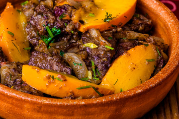 Chicken liver fried with onion and apple. Close-up