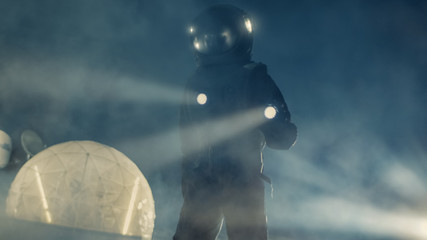 Courageous Astronaut in the Space Suit Holds Flashlight and Explores Alien Planet Covered in Mist and Smoke. Adventure. Interstellar Space Travel, Habitable World and Colonization Concept.