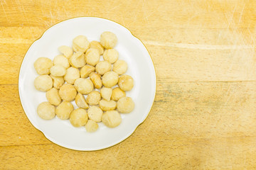 Plate with macadamia nuts. View from above.