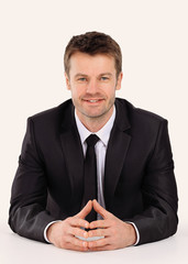 confident businessman sitting at the table.