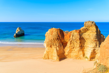 View of beautiful beach with rocks in Portimao town, Algarve, Portugal