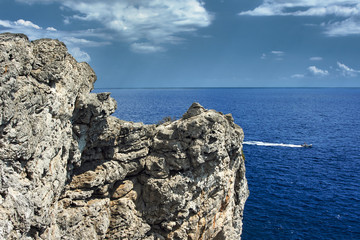 Motorboat and rocky coast of the Greek island of Rhodes.