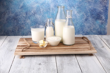 milk products. tasty healthy dairy products on a table on. sour cream in a bowl, cottage cheese bowl, cream in a a bank and milk jar, glass bottle and in a glass