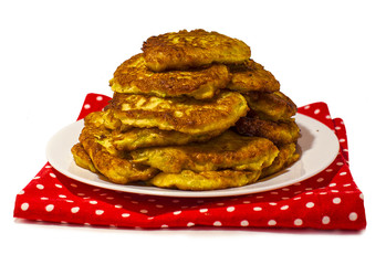 Fried pancakes of their zucchini on a white plate