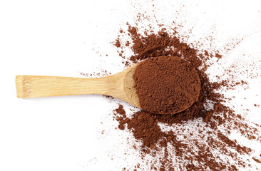 pile cocoa powder with wooden spoon isolated on white background