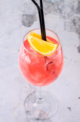 Classic Italian Aperol Spritz cocktail consisting of prosecco, aperitif and soda water with orange slice fresh fruit in wineglass on background. Exotic red summer drink. Bar alcohol menu