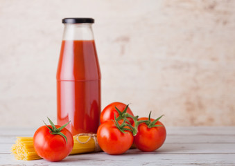Glass bottle of tomato paste with raw spaghetti