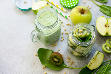 Green smoothies and  apple, kiwi, spinach, pine nuts. Healthy vegan food concept. Copy space.