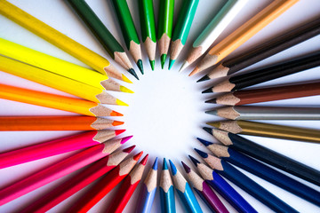 Multicolor pencils forming a color circle isolated on white background