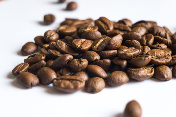 Coffee beans on white background, close up