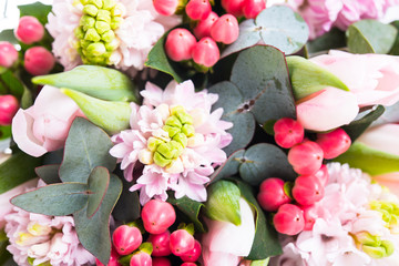 Bunch of pink hyacinths, decorative berries and tulips, festive 