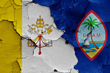flag of Vatican and Guam painted on cracked wall