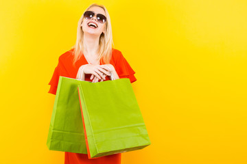 Blonde woman in dress with bags