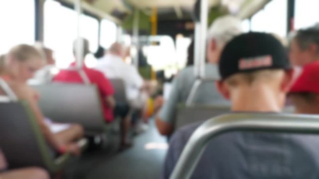 People riding on the public city bus with his family