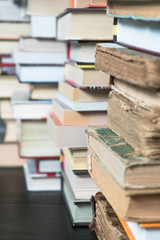 Many books in a bookstore or library on wooden background with copy space