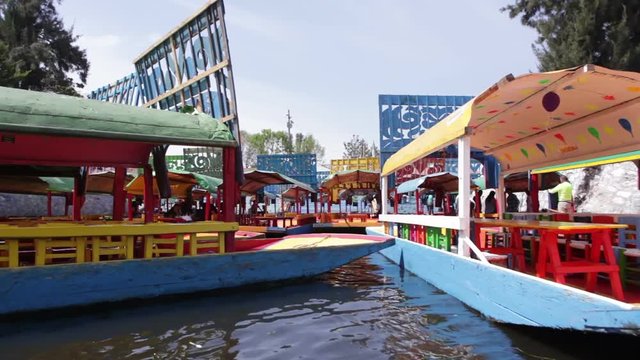 MEXICO CITY, MEXICO - FEBRUARY 04, 2018: Hand painted trajineras chowing the traditional colors of Mexico, a beautiful unique waterline that provides tours to people around the world