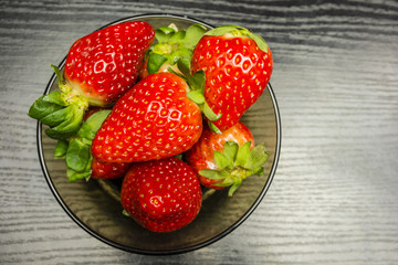 Top view of a bowl of red ripe strawberries.