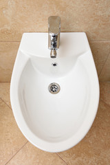Bidet is white in the bathroom, new. Bidet - the device to wash