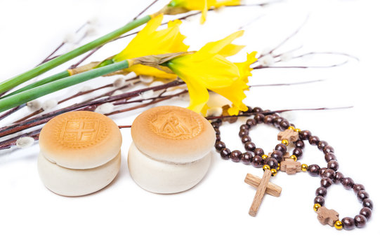 Orthodox prosphoras, prayer beads, yellow flower Narcissus and branches of flowering willow  isolated on white background. The feast of palm Sunday