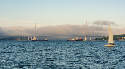 Russian Bridge and ships surrounded by the fog, Russia, Vladivostok